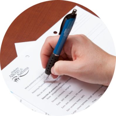 Patient filling out a questionnaire with a pen